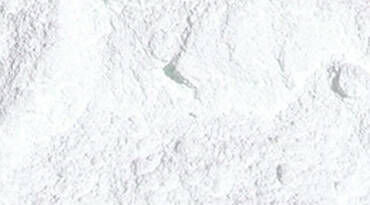 A close-up view of a fine, white powder with a textured surface.