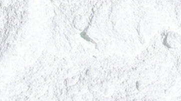 A close-up view of a fine, white powder with a textured surface.