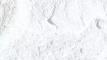 A close-up view of a fine, white powder with a textured surface.