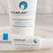 Two tubes of cream are displayed on a marble surface. One is labeled "Cicaplast Mains" and the other "Cicaplast Levres," both indicating they are barrier repairing products. A glass container with cotton swabs is visible in the background.