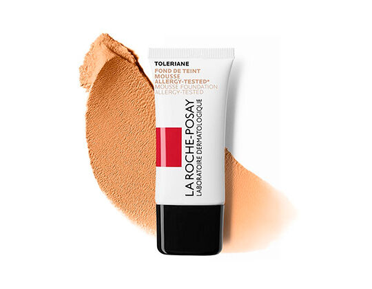 A tube of La Roche-Posay Toleriane foundation stands next to a swatch of beige foundation on a white background.