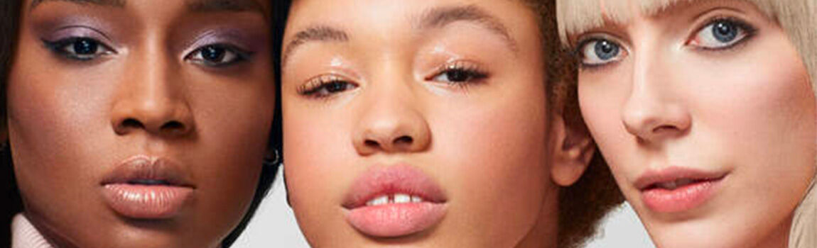 A close-up of three women with diverse skin tones and features, displaying a range of makeup styles.