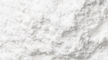 A close-up view of a soft, white powder with a slightly textured surface.