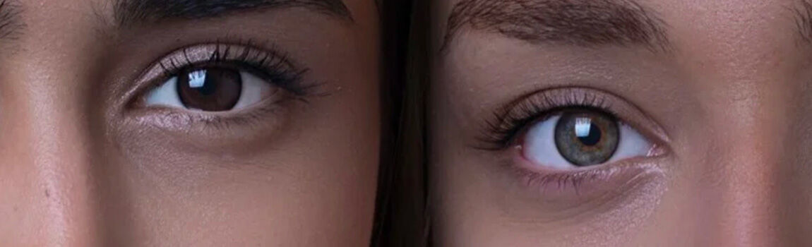 Close-up of two pairs of eyes side by side, one with dark brown irises and the other with greenish-blue irises.