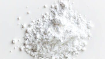 A small pile of white powder scattered on a plain surface.