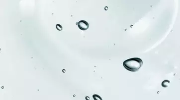 Close-up of water droplets suspended on a clear surface, creating a serene and soothing visual.