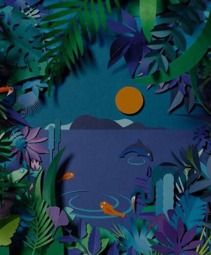 A tube of La Roche-Posay Anthelios sunscreen stands in front of a colorful, layered paper landscape depicting the sun, mountains, and tropical foliage.