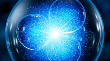 Une illustration d'une sphere representant des bulles bleues lumineuses se rejoignant au centre, symbolisant des concepts scientifiques ou atomiques.