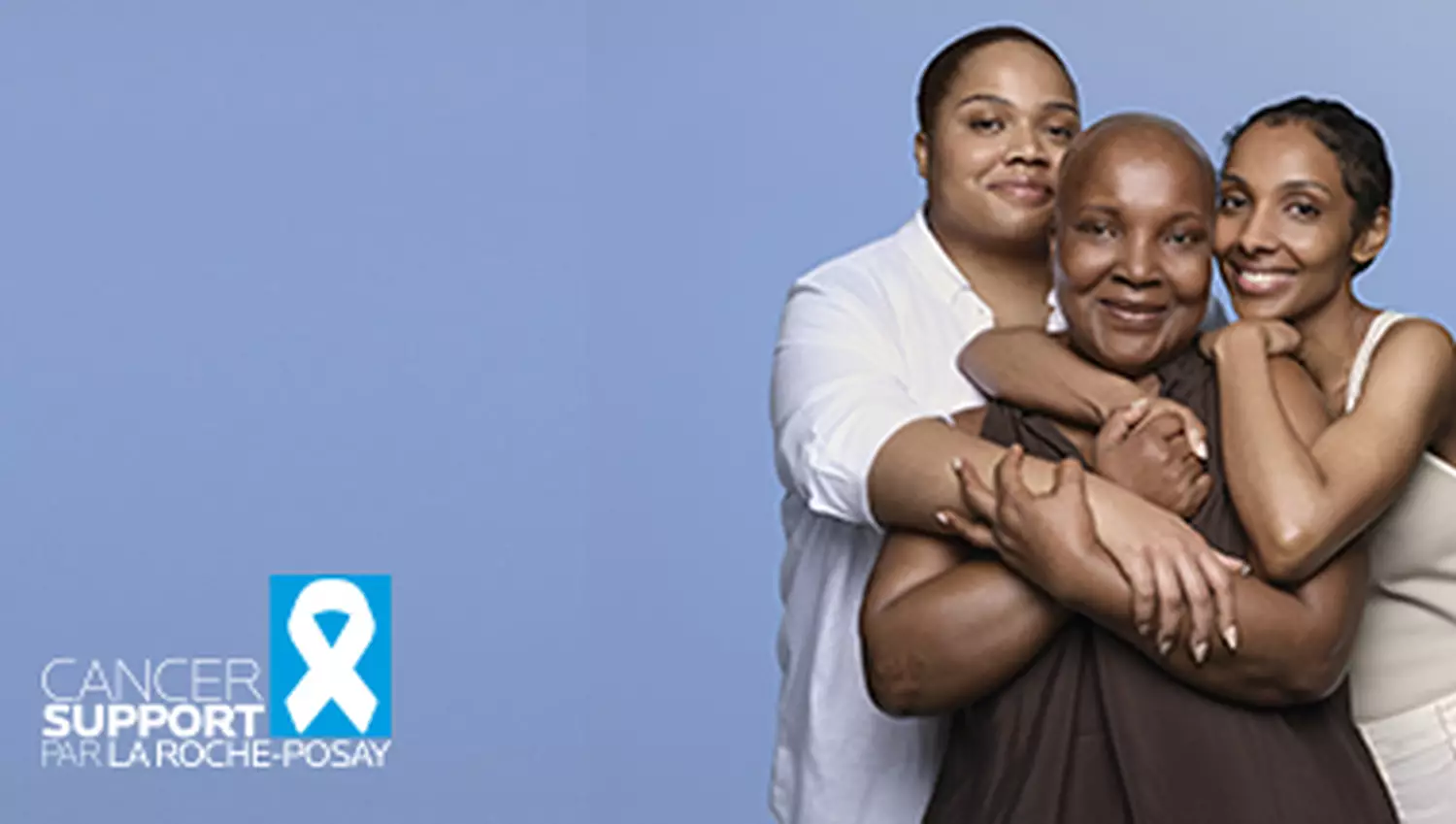 Trois femmes souriantes s'enlacant sur un fond bleu, avec le logo « Cancer Support par La Roche-Posay ».