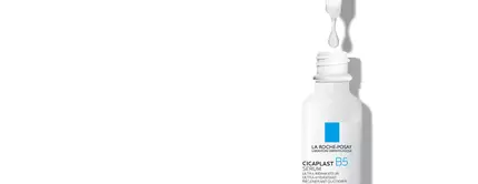 Bouteille de serum Cicaplast B5 de La Roche-Posay avec une goutte tombant du compte-gouttes, sur fond blanc.