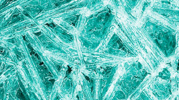 Close-up of textured ice with intricate, crystalline patterns and a turquoise hue.