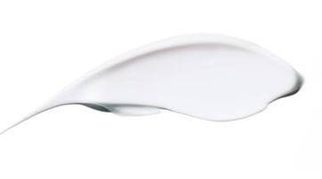 A smooth, curved streak of white cream or lotion on a plain background.