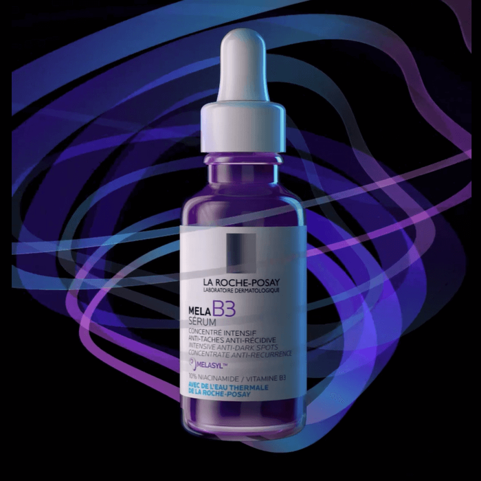 A dark background features a bottle of La Roche-Posay Mela B3 Serum, showcasing its purple liquid and dropper design. The bottle is illuminated with soft blue and purple lighting.